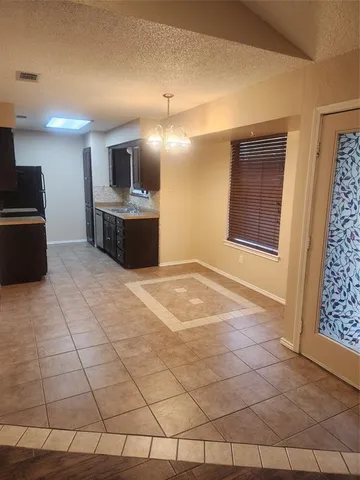 a view of a kitchen with a sink and a refrigerator