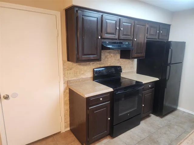 a kitchen with a stove and a refrigerator