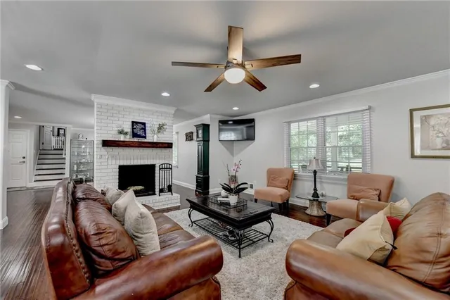 a kitchen with stainless steel appliances granite countertop a stove a refrigerator a kitchen island a table and chairs