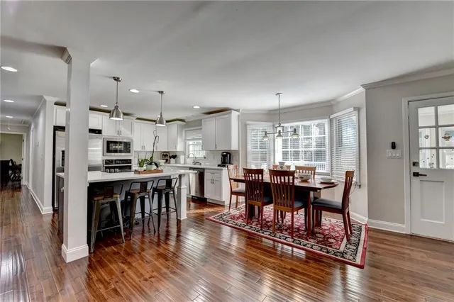 a kitchen with stainless steel appliances granite countertop a sink stove and cabinets