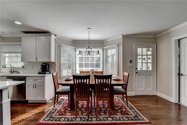 a view of a dining room with furniture window and wooden floor