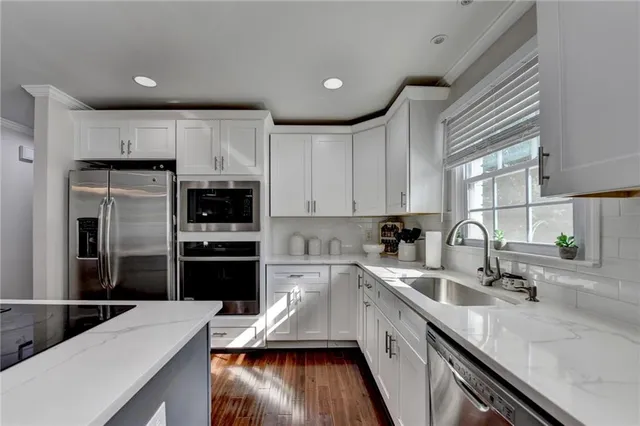 a bedroom with a bed lamps and a large mirror