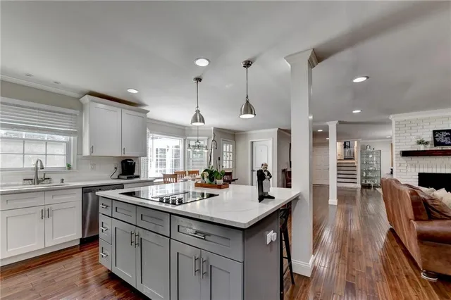 a bathroom with a granite countertop sink a toilet and shower