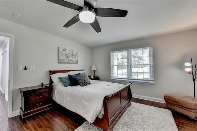a living room with furniture ceiling fan and a window