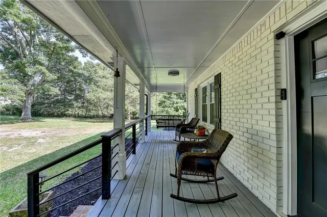 a living room with furniture a fireplace and a window