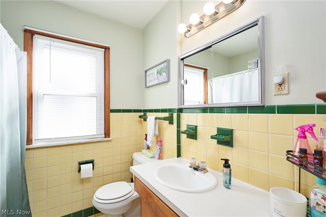1359 Beaconfield Road Lyndhurst, OH 44124 - Photo 7 of 26 Full bathroom with vanity, a shower with shower curtain, and tile walls