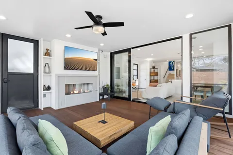 a living room with furniture and a potted plant