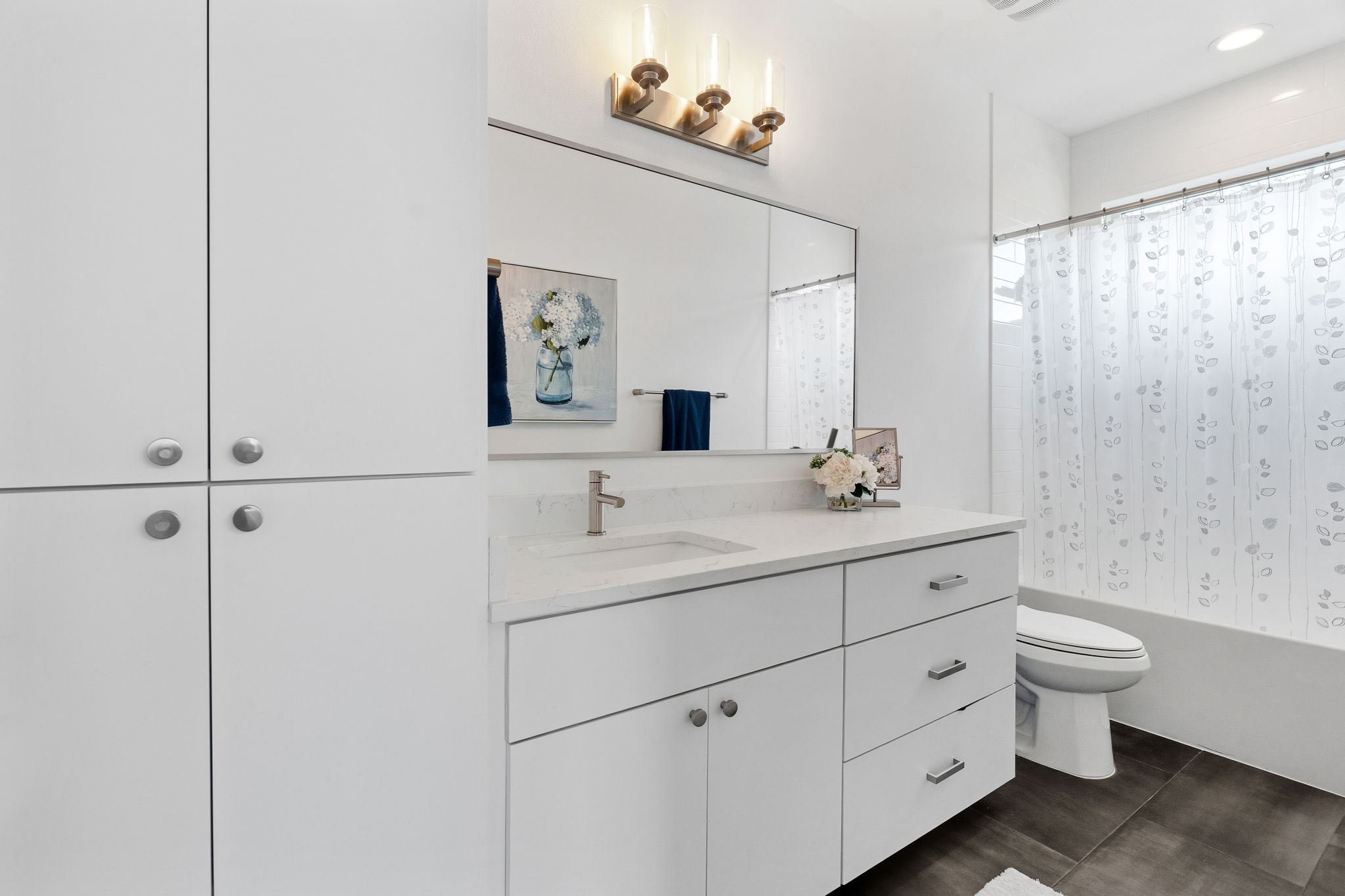 2508 Paramount Avenue, Unit B Austin, TX 78704 - Photo 26 of 40 The secondary ensuite bathroom boasts gorgeous contemporary cabinetry, a spacious quartz topped vanity, and a shower/tub combo with tiled backsplash.
