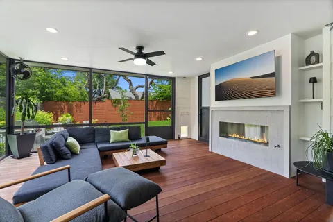 a living room with furniture a fireplace and a flat screen tv