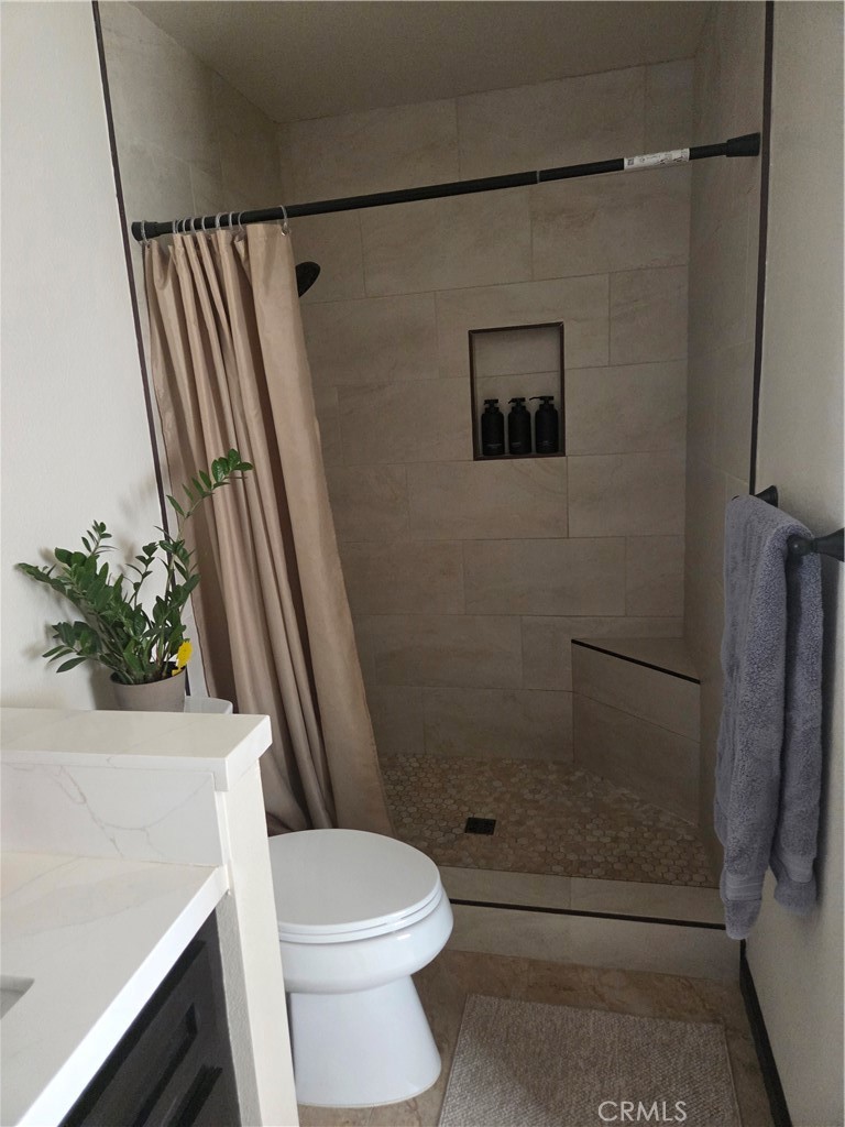 13955 Iroquois Road Apple Valley, CA 92307 - Photo 13 of 19 a bathroom with a shower and a toilet