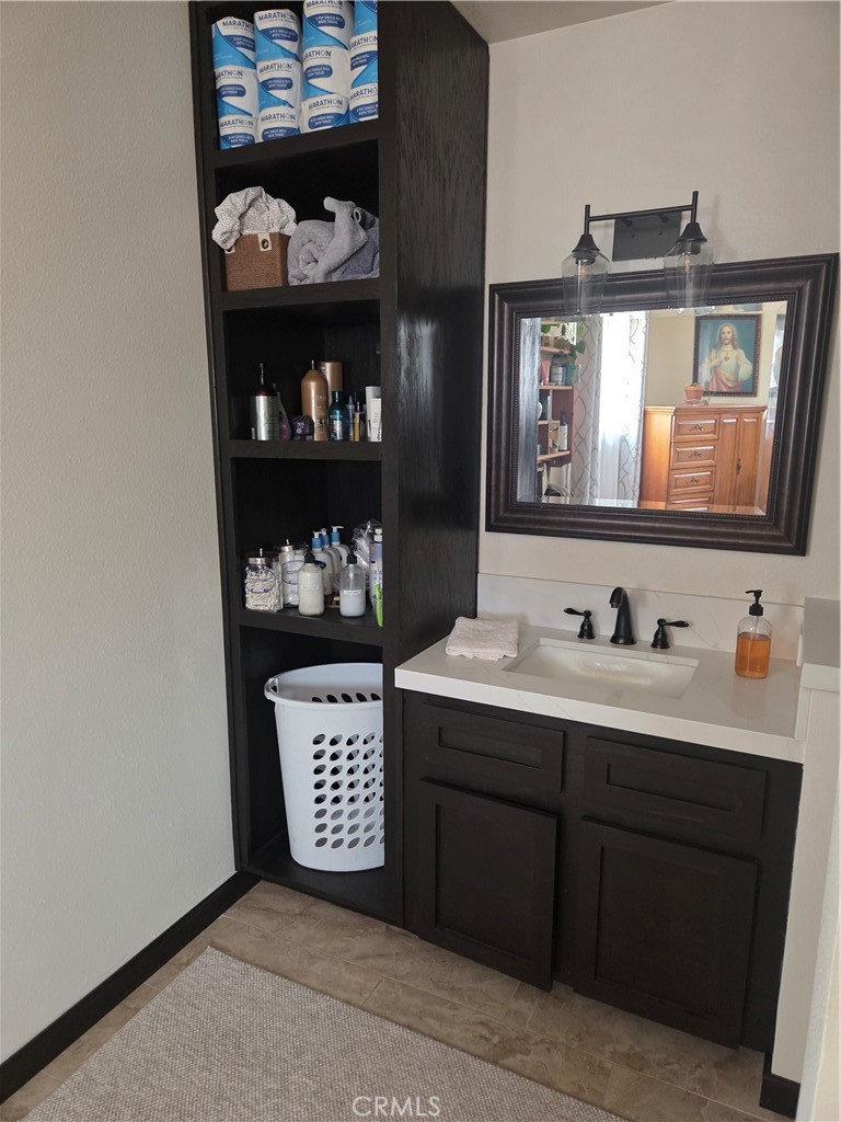 13955 Iroquois Road Apple Valley, CA 92307 - Photo 14 of 19 a bathroom with a sink and a mirror