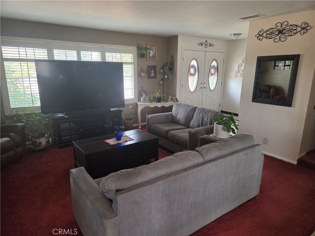 13955 Iroquois Road Apple Valley, CA 92307 - Photo 3 of 19 a living room with furniture and a flat screen tv