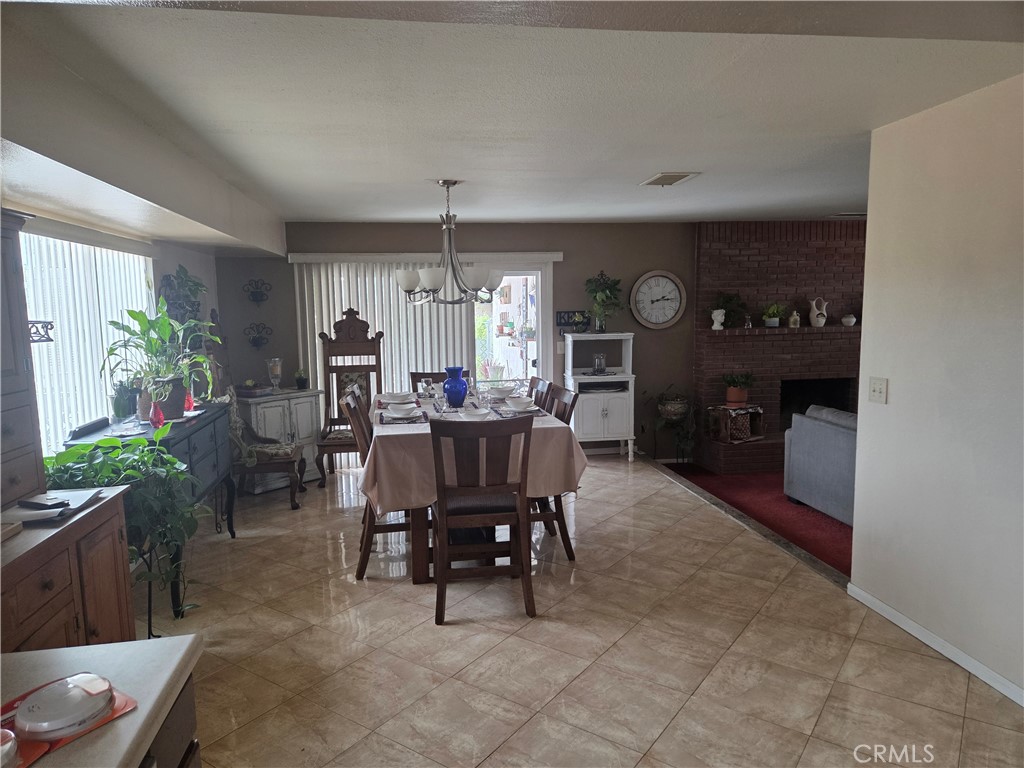 13955 Iroquois Road Apple Valley, CA 92307 - Photo 7 of 19 a view of a dining room with furniture and a chandelier