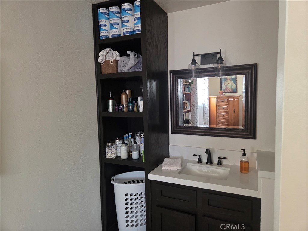 13955 Iroquois Road Apple Valley, CA 92307 - Photo 10 of 19 a bathroom with a sink and a mirror