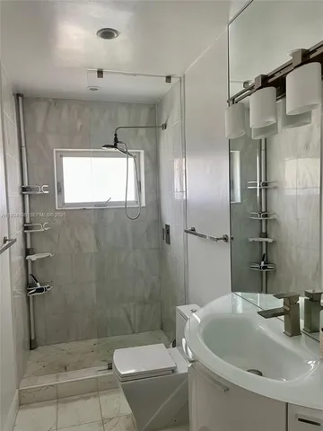 a bathroom with a sink toilet and shower