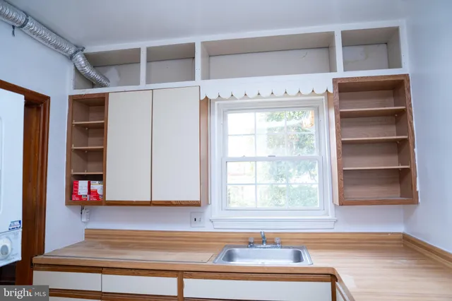 a view of a room with shelves and a window