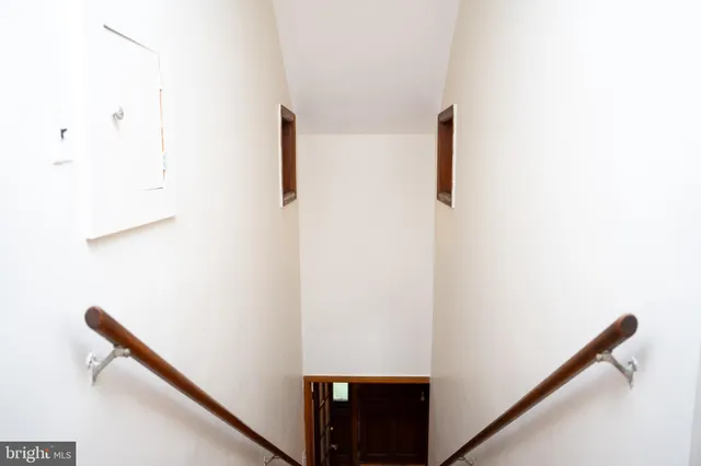 a view of staircase with white walls
