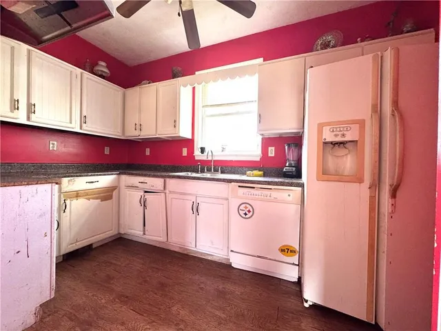 a kitchen with granite countertop a refrigerator and a stove