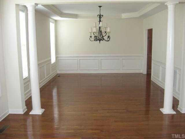 2916 Elmfield Street Raleigh, NC 27614 - Photo 5 of 10 Very stately and spacious dining room with gleaming hardwoods, trey ceiling, crown moldings and wainescoating on all walls.