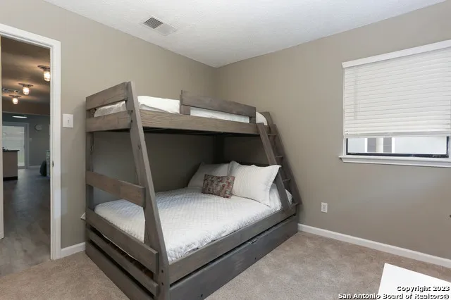 a bedroom with a bed and window