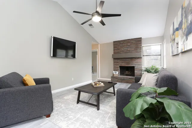 a living room with furniture and a fireplace
