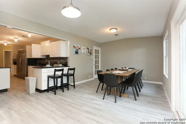 a view of a dining room with furniture and wooden floor