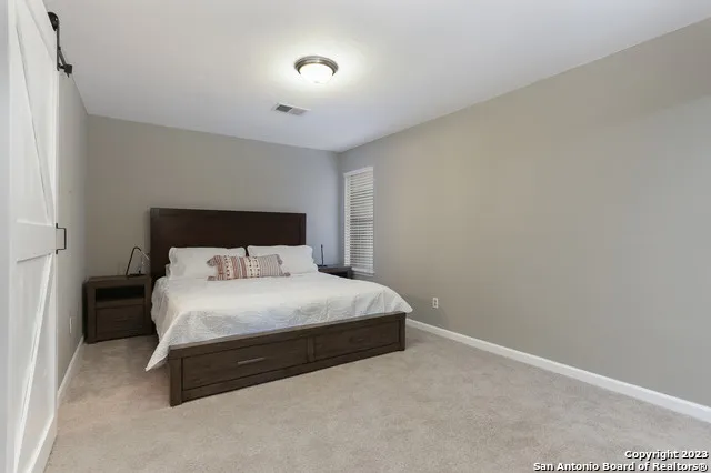 a bedroom with a bed and a night stand