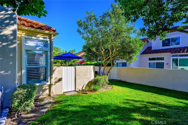 a view of a house with a yard and sitting area