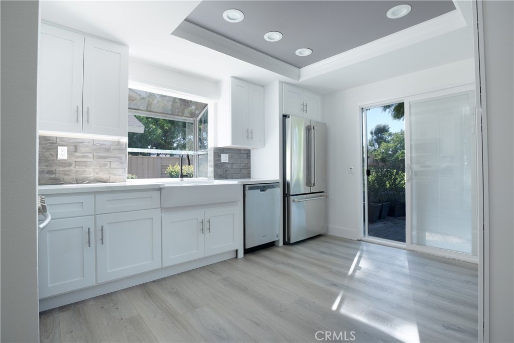13 Brookmont, Unit 60 Irvine, CA 92604 - Photo 11 of 27 a kitchen with white cabinets and window