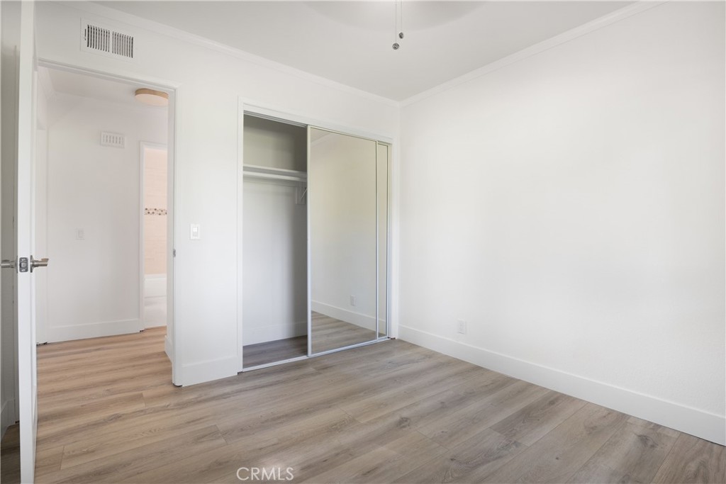 13 Brookmont, Unit 60 Irvine, CA 92604 - Photo 17 of 27 an empty room with wooden floor and closet