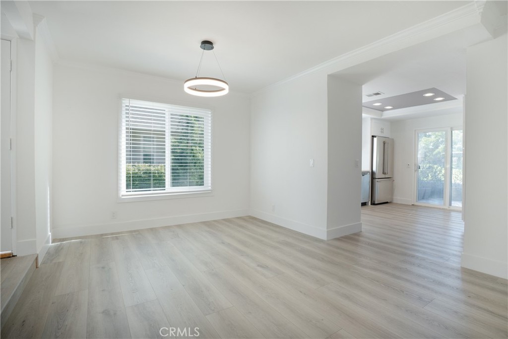 13 Brookmont, Unit 60 Irvine, CA 92604 - Photo 26 of 27 an empty room with wooden floor and windows