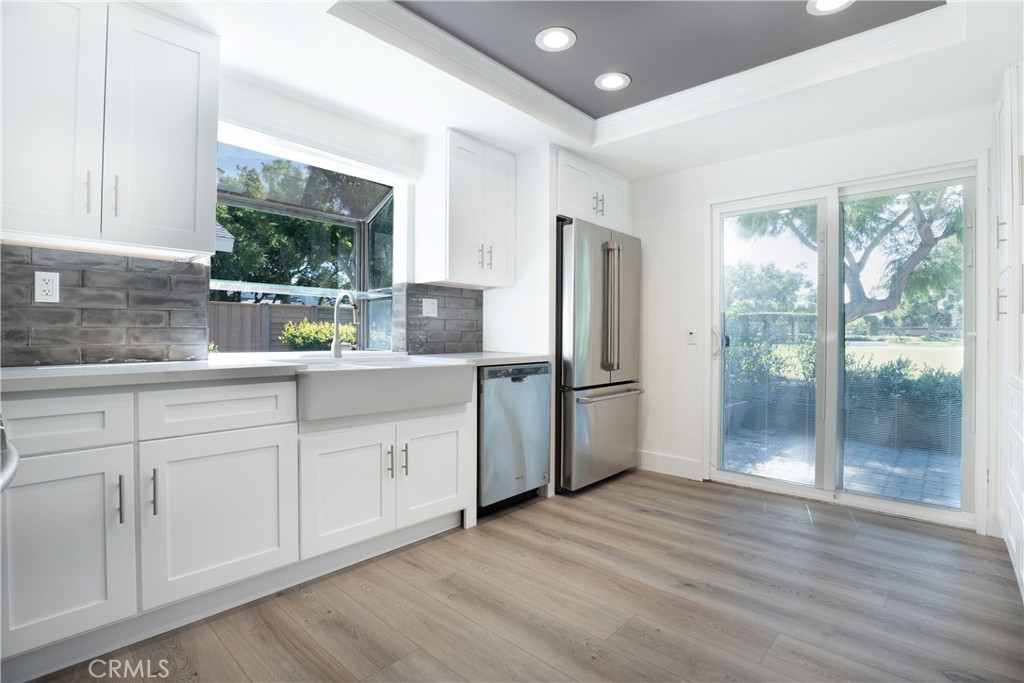 13 Brookmont, Unit 60 Irvine, CA 92604 - Photo 27 of 27 a kitchen with stainless steel appliances granite countertop a refrigerator a sink a stove a microwave and wooden cabinets