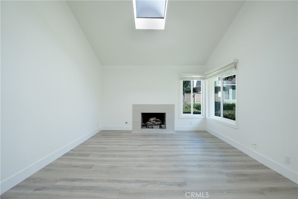 13 Brookmont, Unit 60 Irvine, CA 92604 - Photo 6 of 27 a view of an empty room with a window and fireplace