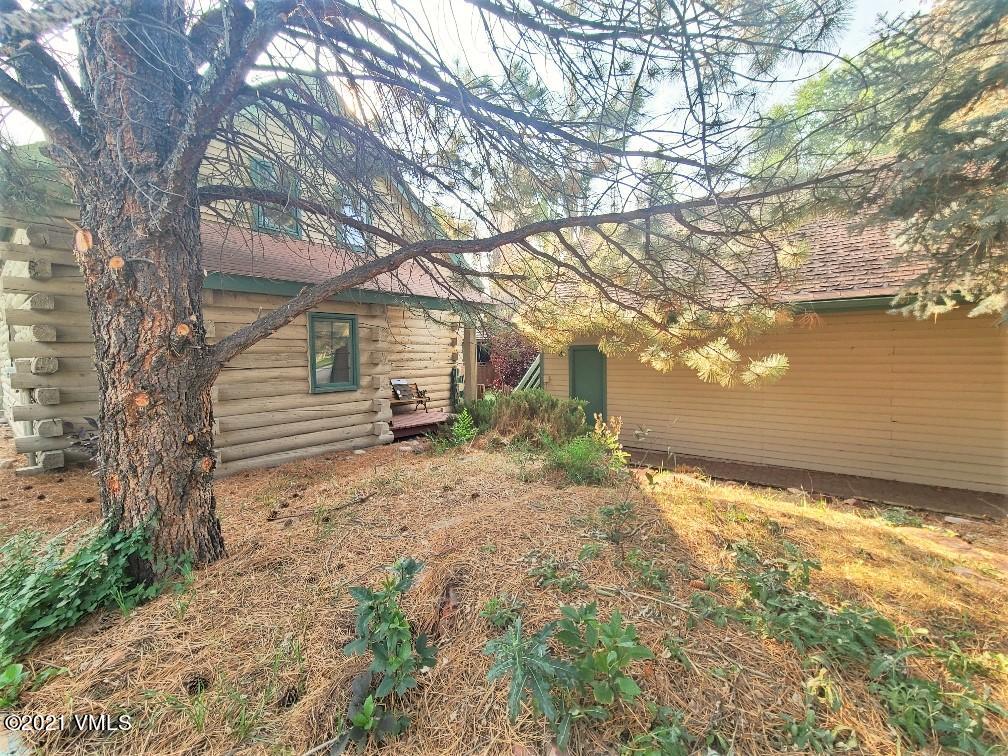 755 Bull Run Eagle, CO 81631 - Photo 5 of 19 a backyard of a house with large trees and wooden fence