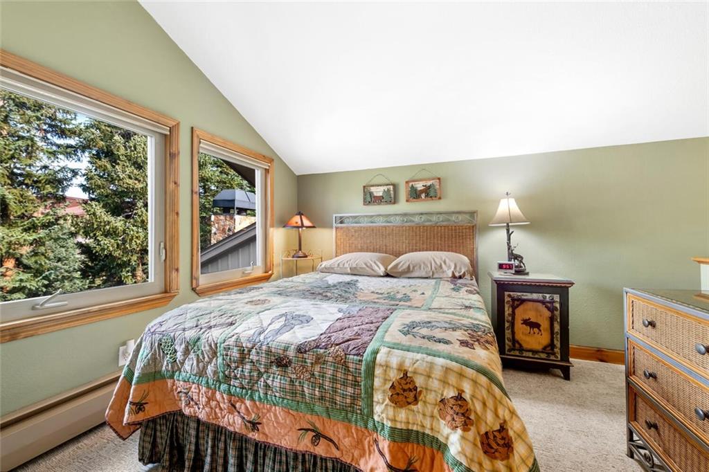 760 Columbine Road, Unit A12 Breckenridge, CO 80424 - Photo 13 of 35 a bedroom with a bed and a window