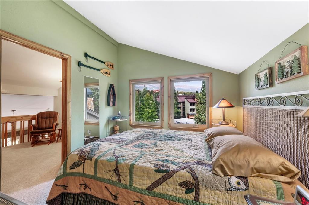 760 Columbine Road, Unit A12 Breckenridge, CO 80424 - Photo 14 of 35 a bedroom with a large bed and a large window