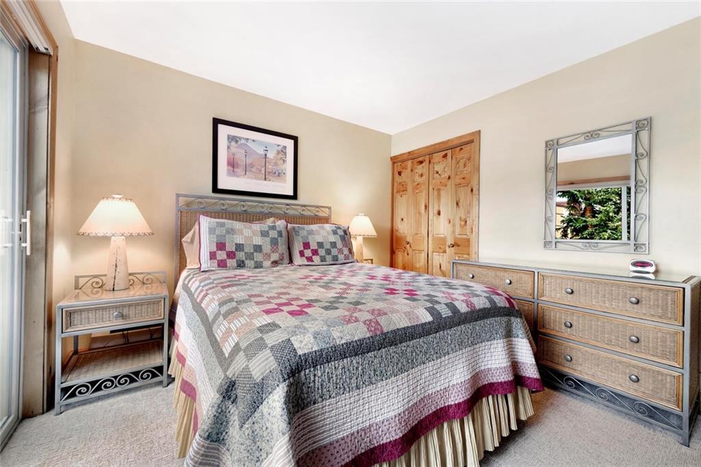 760 Columbine Road, Unit A12 Breckenridge, CO 80424 - Photo 17 of 35 a bedroom with a bed and a window