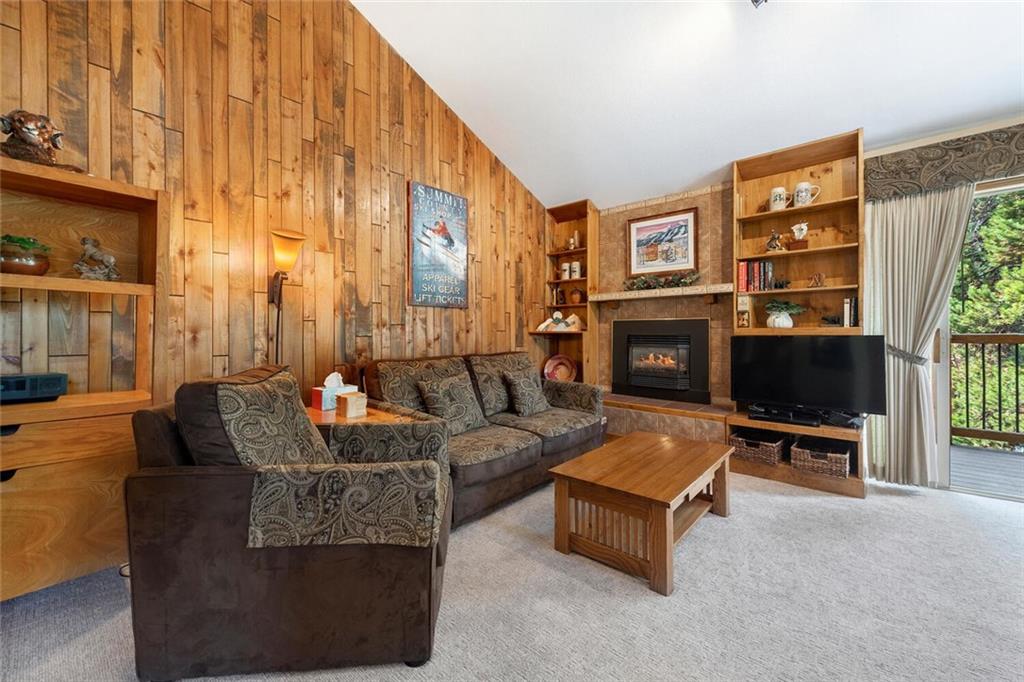 760 Columbine Road, Unit A12 Breckenridge, CO 80424 - Photo 18 of 35 a living room with furniture a flat screen tv and a fireplace
