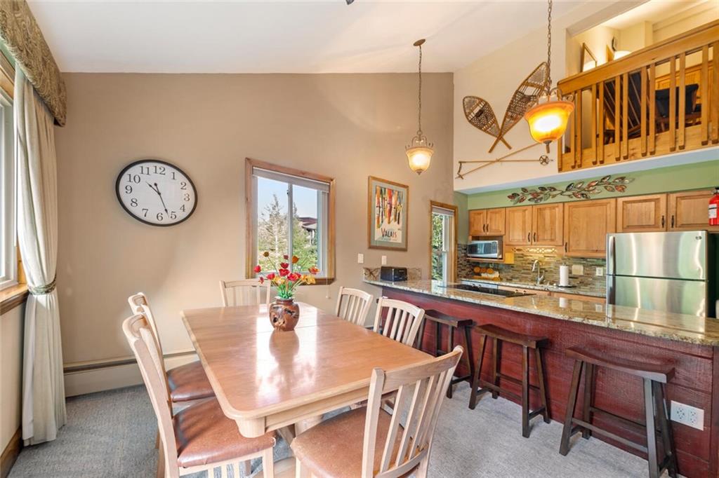 760 Columbine Road, Unit A12 Breckenridge, CO 80424 - Photo 19 of 35 a view of a dining area with furniture window and wooden floor