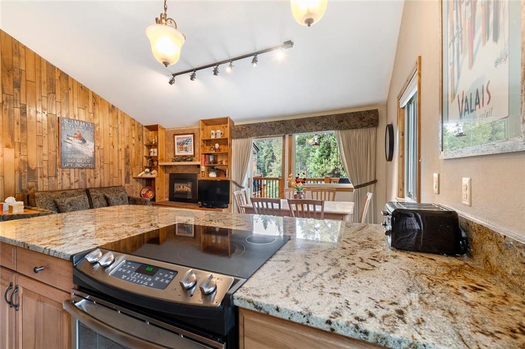 760 Columbine Road, Unit A12 Breckenridge, CO 80424 - Photo 21 of 35 a kitchen with a stove a sink and a refrigerator