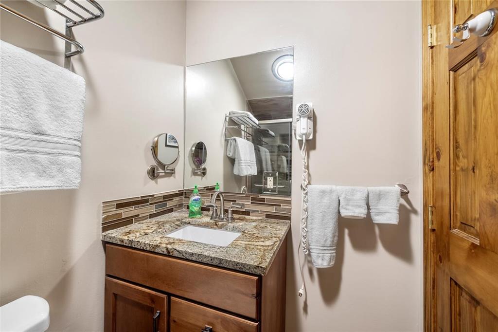 760 Columbine Road, Unit A12 Breckenridge, CO 80424 - Photo 22 of 35 a kitchen with a sink and cabinets