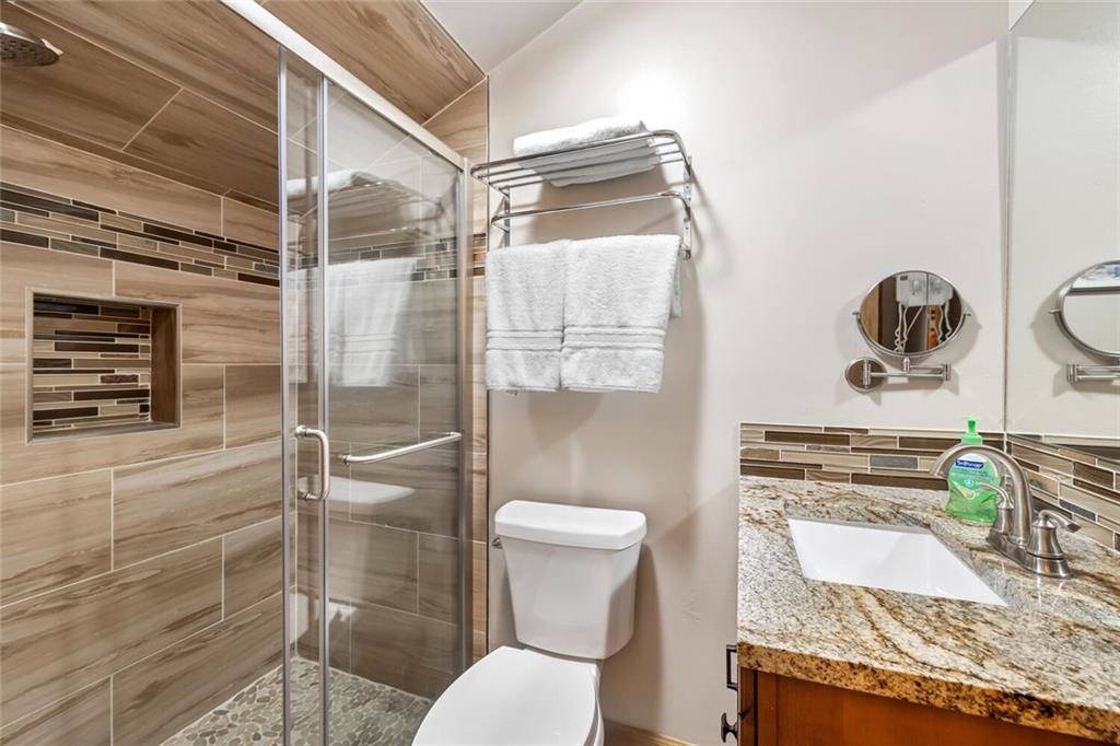760 Columbine Road, Unit A12 Breckenridge, CO 80424 - Photo 4 of 35 a bathroom with a granite countertop sink toilet and shower