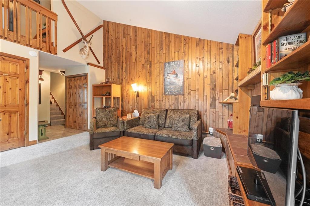 760 Columbine Road, Unit A12 Breckenridge, CO 80424 - Photo 8 of 35 a living room with furniture a fireplace and a large window