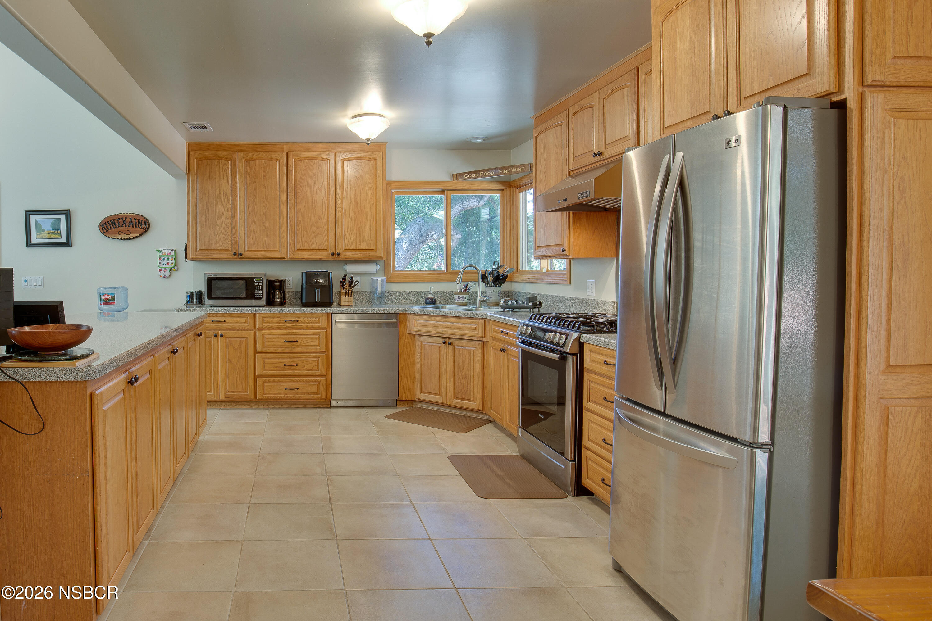 850 Fredensborg Canyon Road Solvang, CA 93463 - Photo 6 of 26 a kitchen with stainless steel appliances granite countertop a refrigerator sink and cabinets