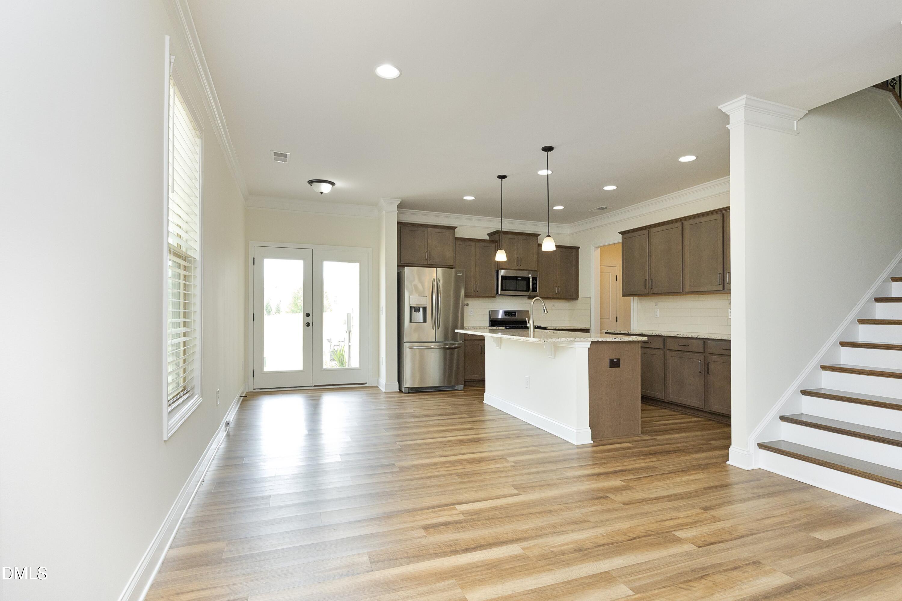 824 Country Downs Road Wake Forest, NC 27587 - Photo 13 of 41 a view of kitchen with wooden floor and window