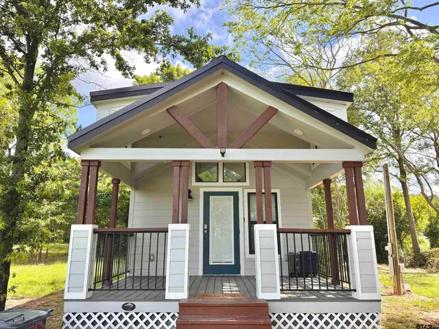 a view of a balcony with wooden floor and fence