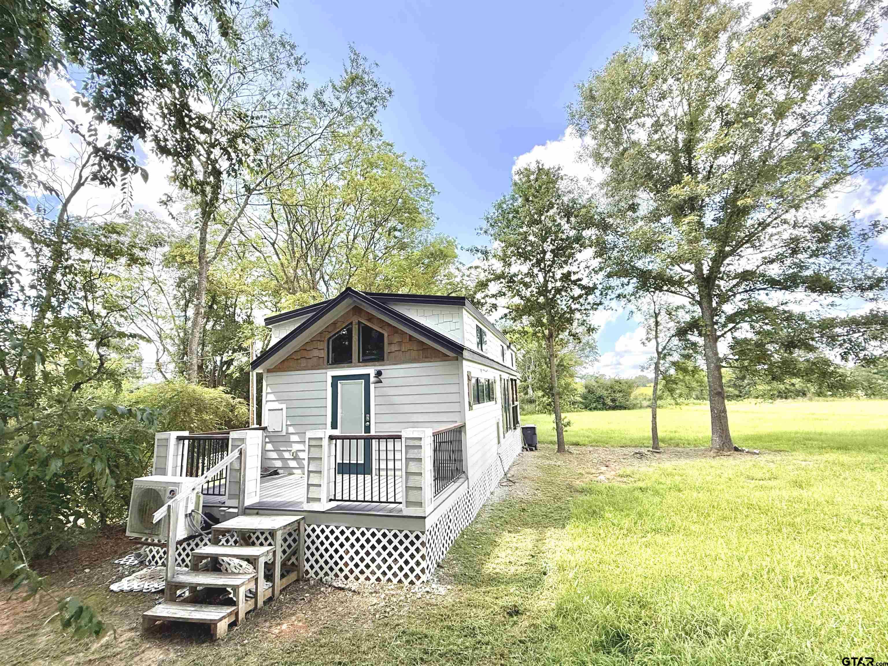 3235 County Road Cookville, TX 75558 - Photo 18 of 38 a front view of a house with a yard