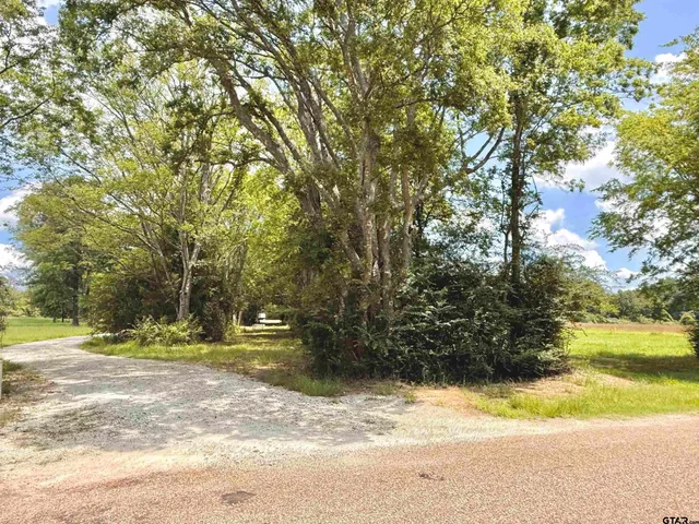 a spacious bedroom with a bed and a large window