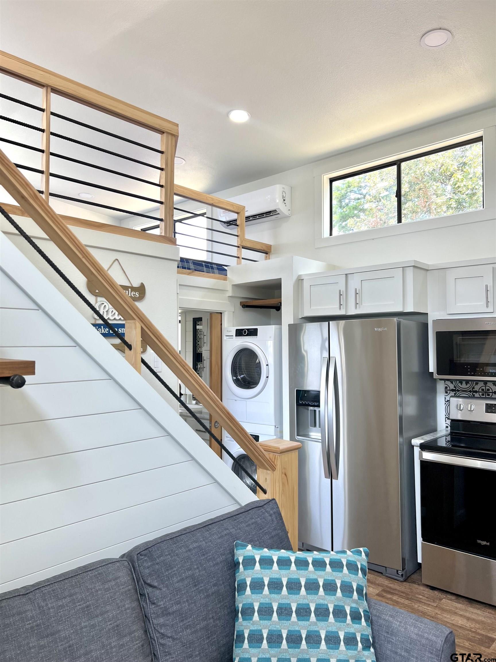 3235 County Road Cookville, TX 75558 - Photo 30 of 38 a kitchen with stainless steel appliances a refrigerator and a window