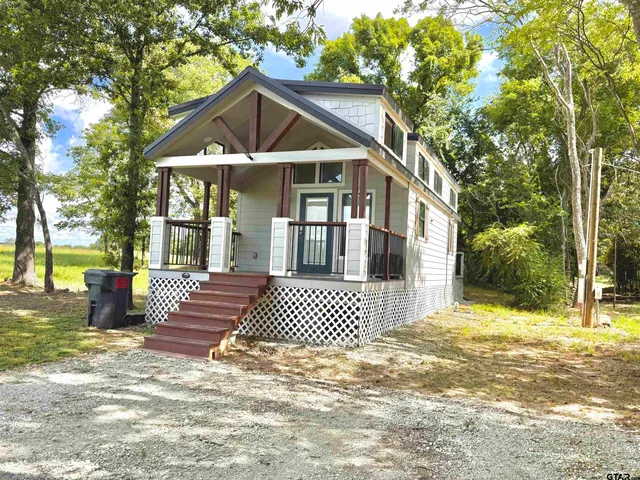 a front view of a house with a big yard